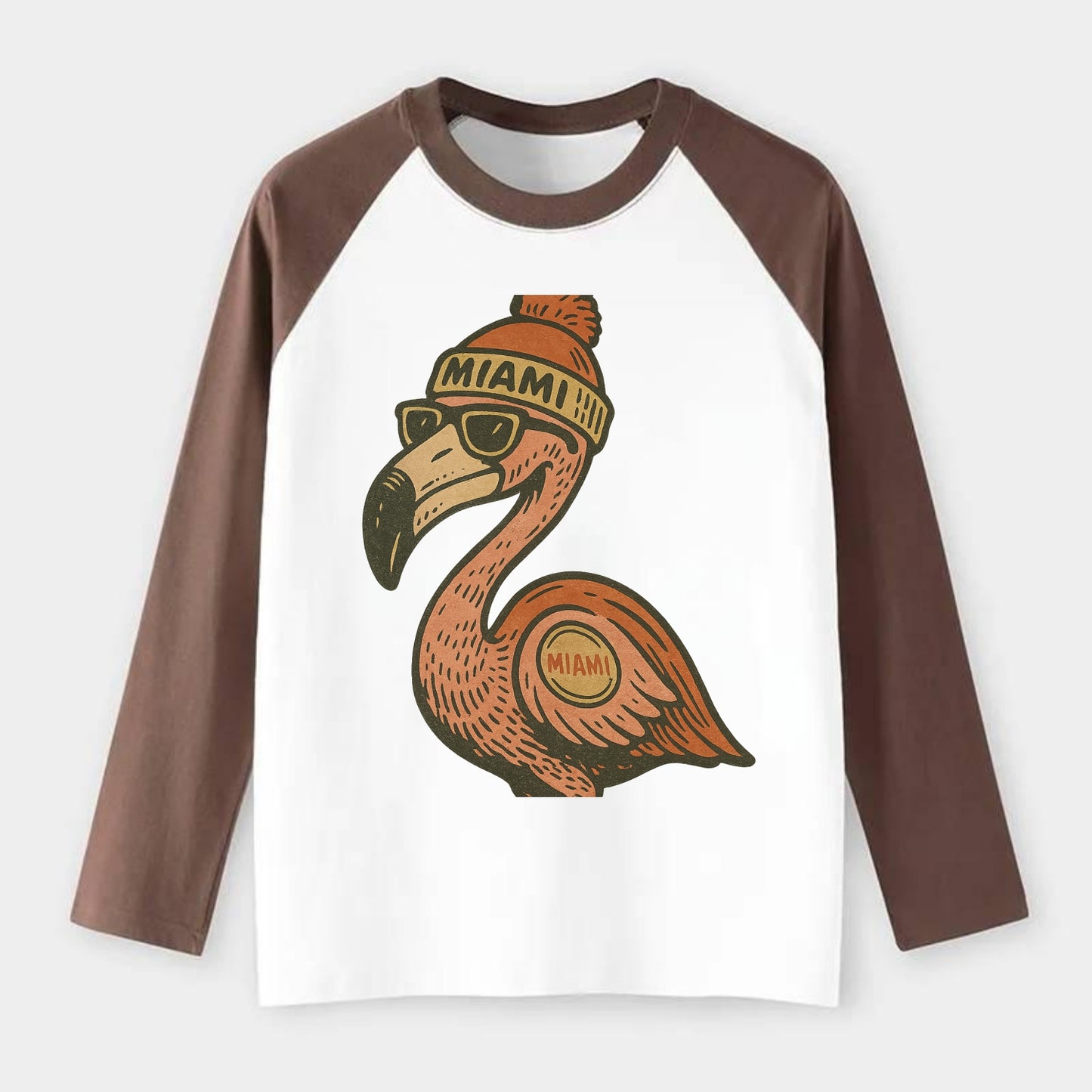 Miami Flamingo wearing Miami beanie with pom pom and wayfarer - Raglan Long Sleeve T-Shirt - Coffee