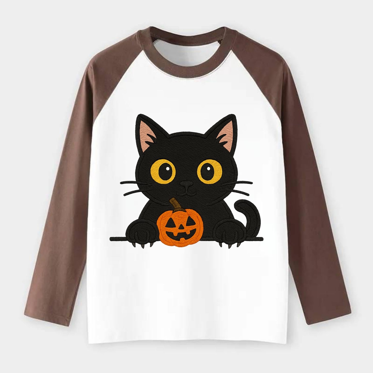 Midnight the black cat wearing round spectacles while studying the - Raglan Long Sleeve T-Shirt - Coffee