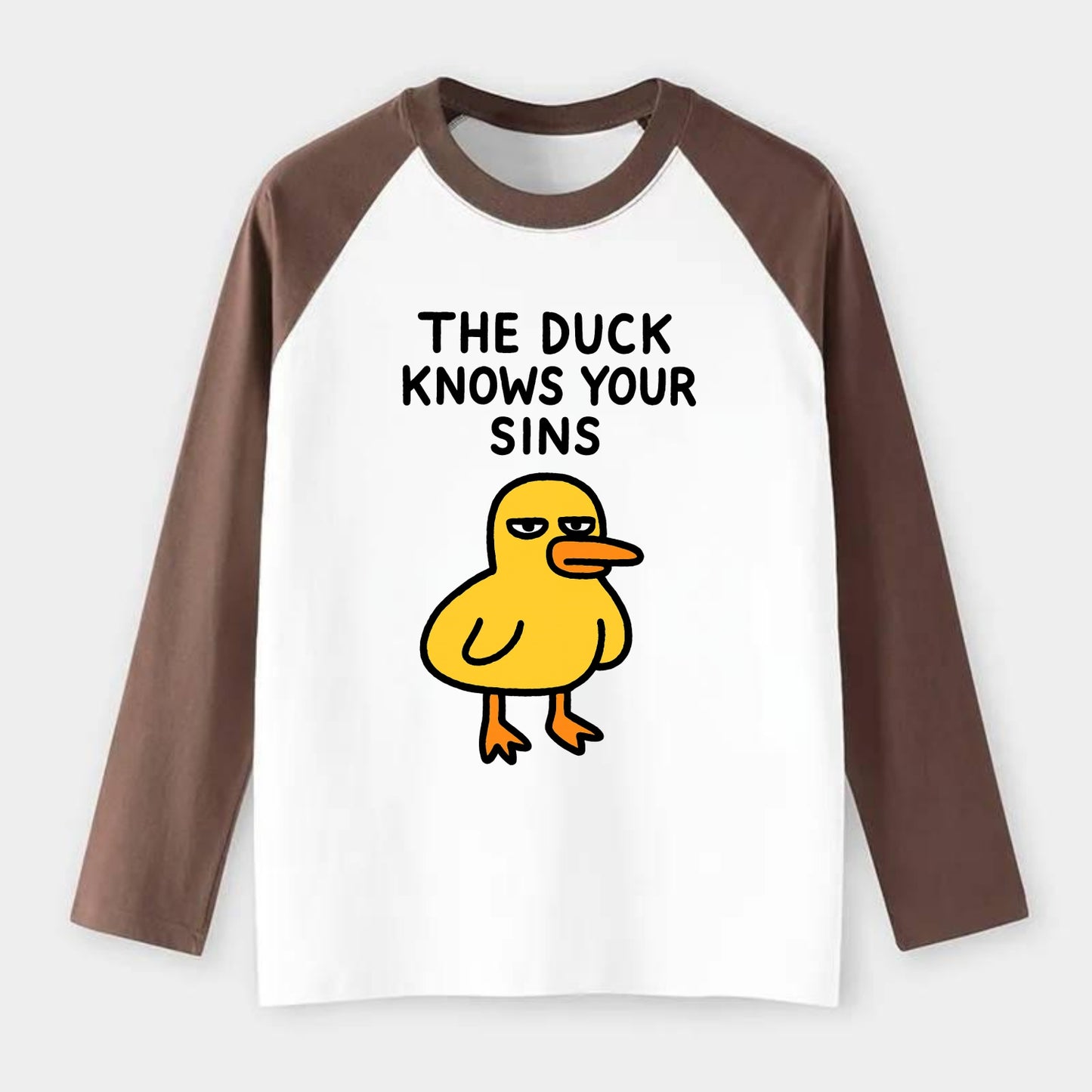 THE DUCK KNOWS YOUR SINS | Yellow duck with judgmental stare - Raglan Long Sleeve T-Shirt - Coffee