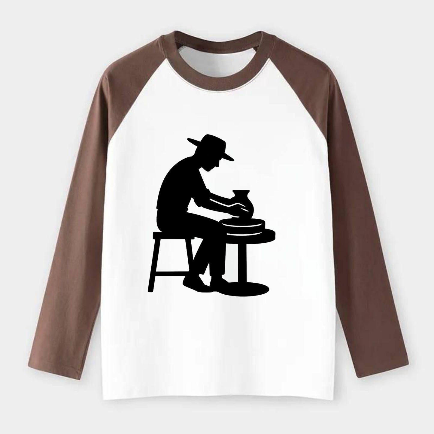 Potter shaping clay on wheel - Raglan Long Sleeve T-Shirt - Coffee