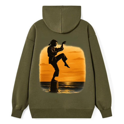 karate crane kick pose on wooden post at beach sunset - Classic Pullover Hoodie - ArmyGreen