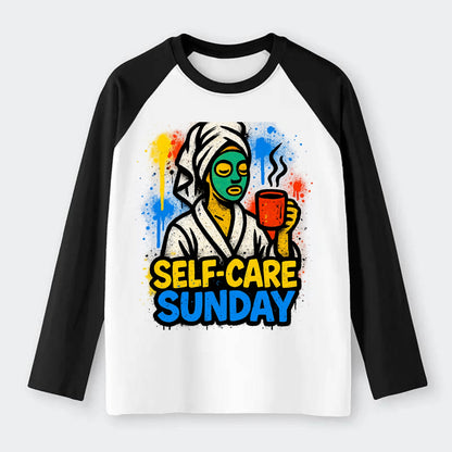 Person in bathrobe with face mask and tea - self-care Sunday ritual, - Raglan Long Sleeve T-Shirt - Black