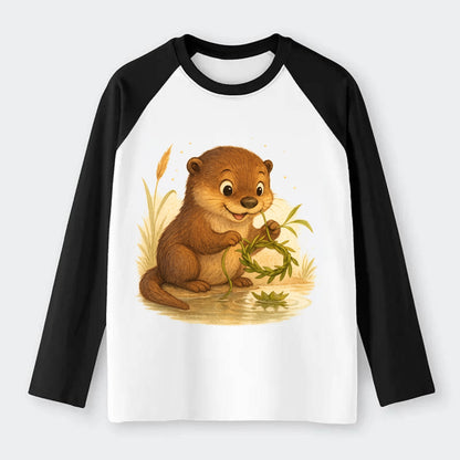 Otter weaving river reeds into a floating crown beside mirror-still - Raglan Long Sleeve T-Shirt - Black