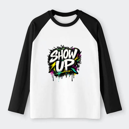 Bold typography design - "SHOW UP" - be present, arrive ready - Raglan Long Sleeve T-Shirt - Black
