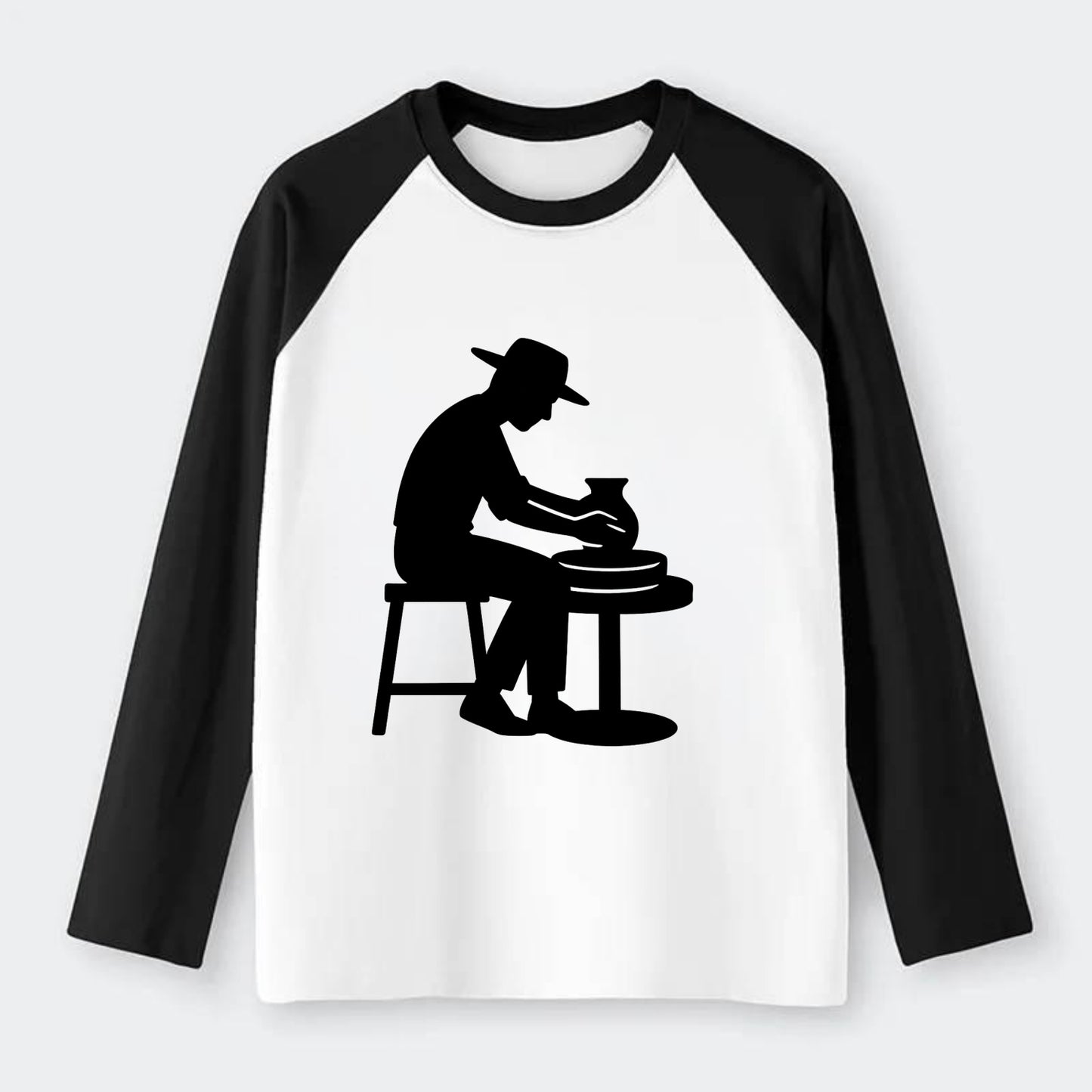 Potter shaping clay on wheel - Raglan Long Sleeve T-Shirt - Black