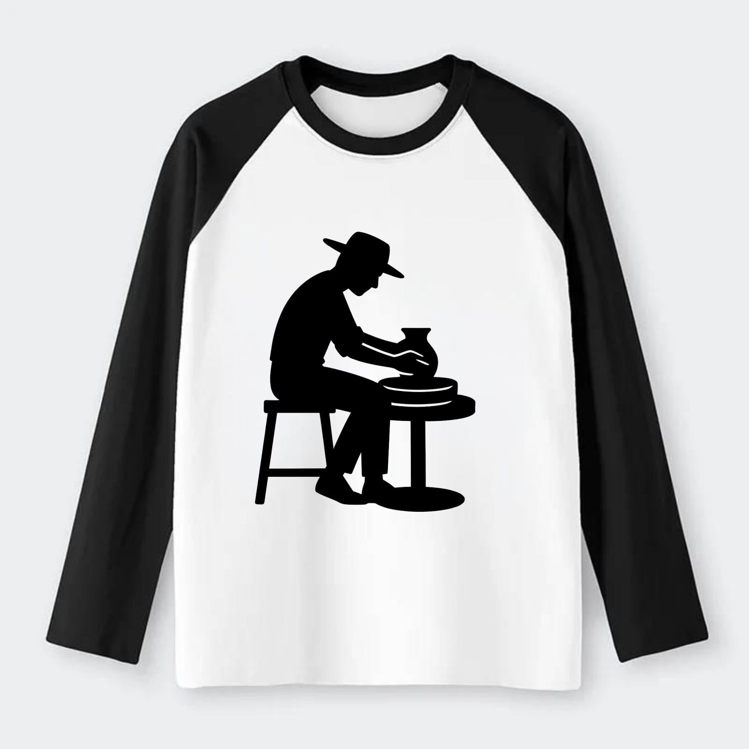 Potter shaping clay on wheel - Raglan Long Sleeve T-Shirt - Black