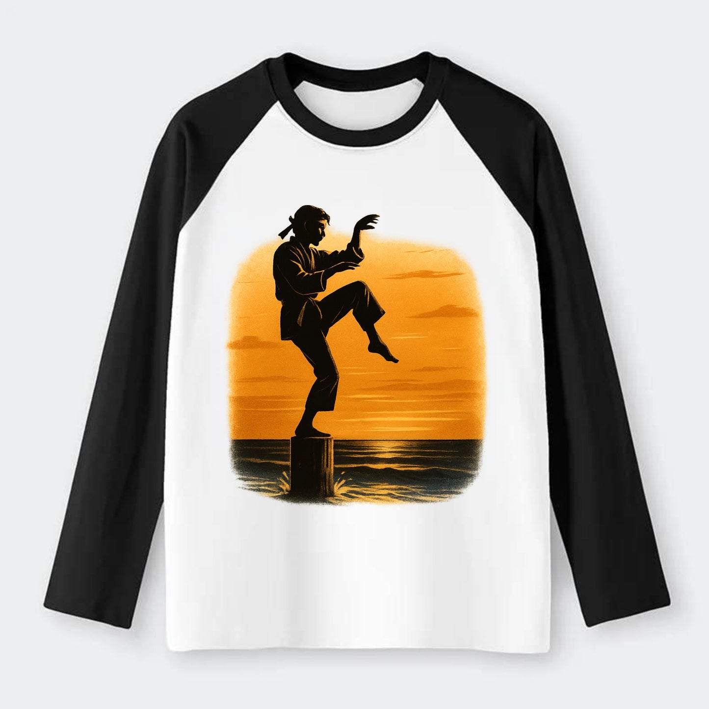 karate crane kick pose on wooden post at beach sunset - Raglan Long Sleeve T-Shirt - Black