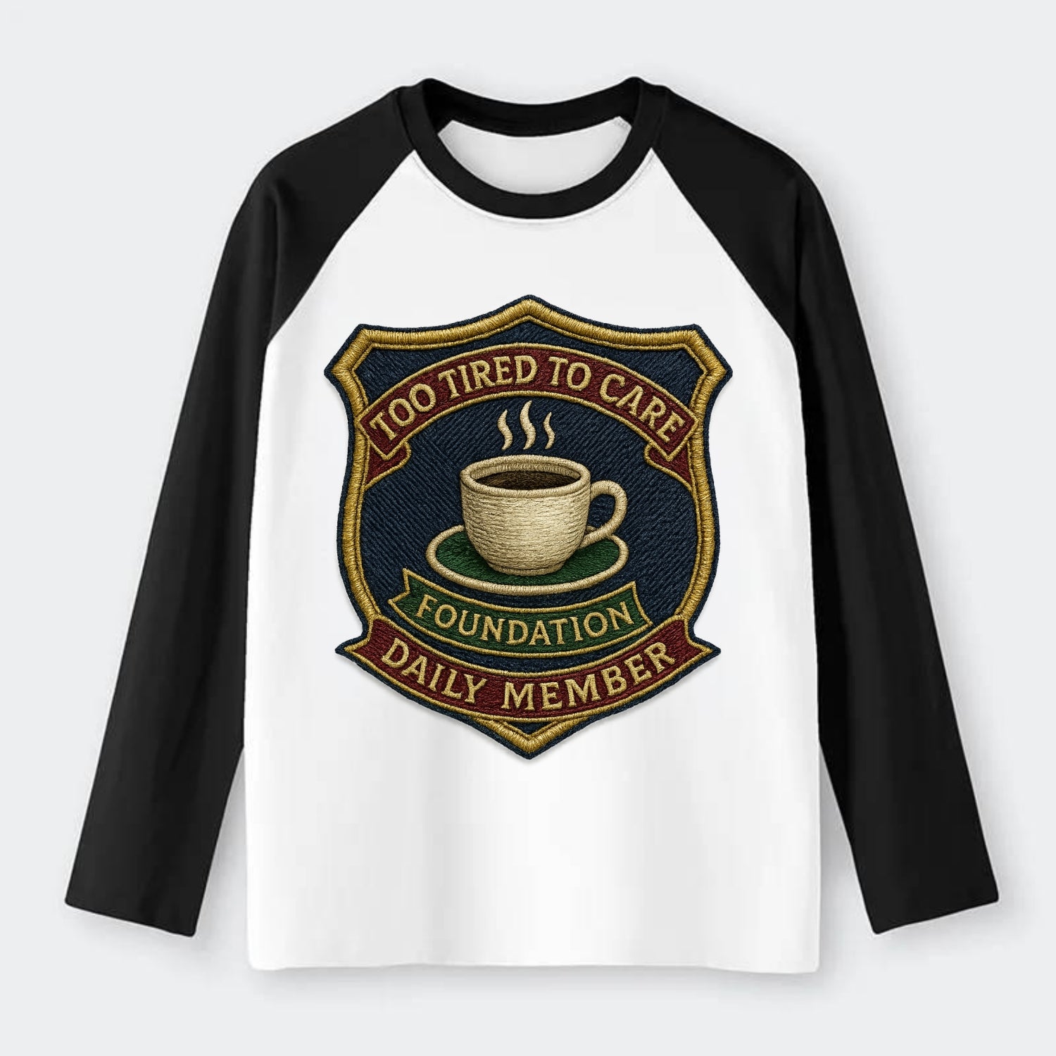 Crest with coffee cup - "Too Tired To Care Foundation - Daily Member" - Raglan Long Sleeve T-Shirt - Black