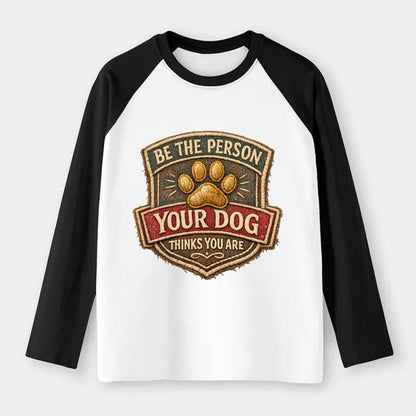 BE THE PERSON YOUR DOG THINKS YOU ARE - inspirational with paw in gold - Raglan Long Sleeve T-Shirt - Black