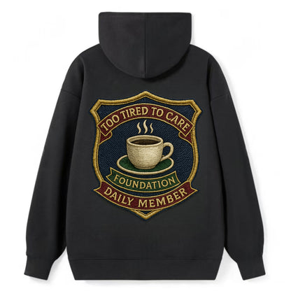 Crest with coffee cup - "Too Tired To Care Foundation - Daily Member" - - Classic Pullover Hoodie - Black