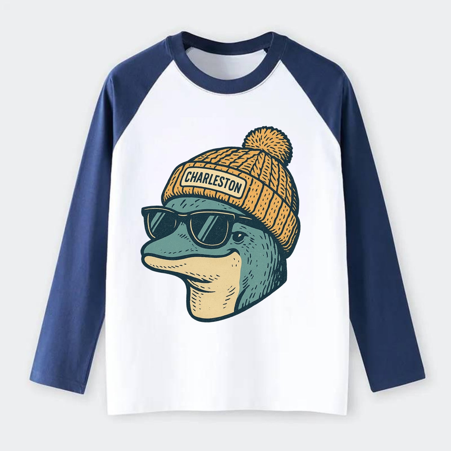 Charleston Dolphin wearing Charleston beanie with pom pom and wayfarer - Raglan Long Sleeve T-Shirt - Blue