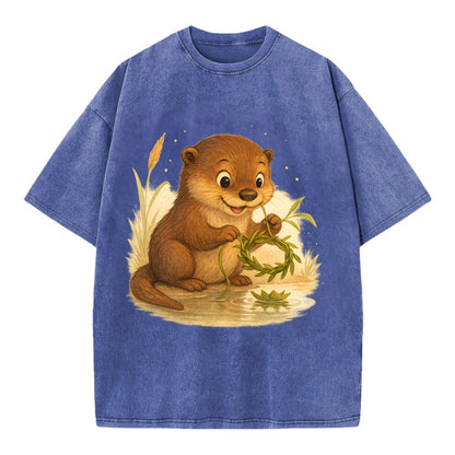 Otter weaving river reeds into a floating crown beside mirror-still water - Vintage T-shirt - Blue