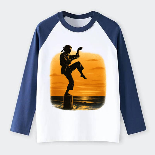 karate crane kick pose on wooden post at beach sunset - Raglan Long Sleeve T-Shirt
