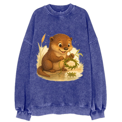 Otter weaving river reeds into a floating crown beside mirror-still water - Vintage Sweatshirt - Blue