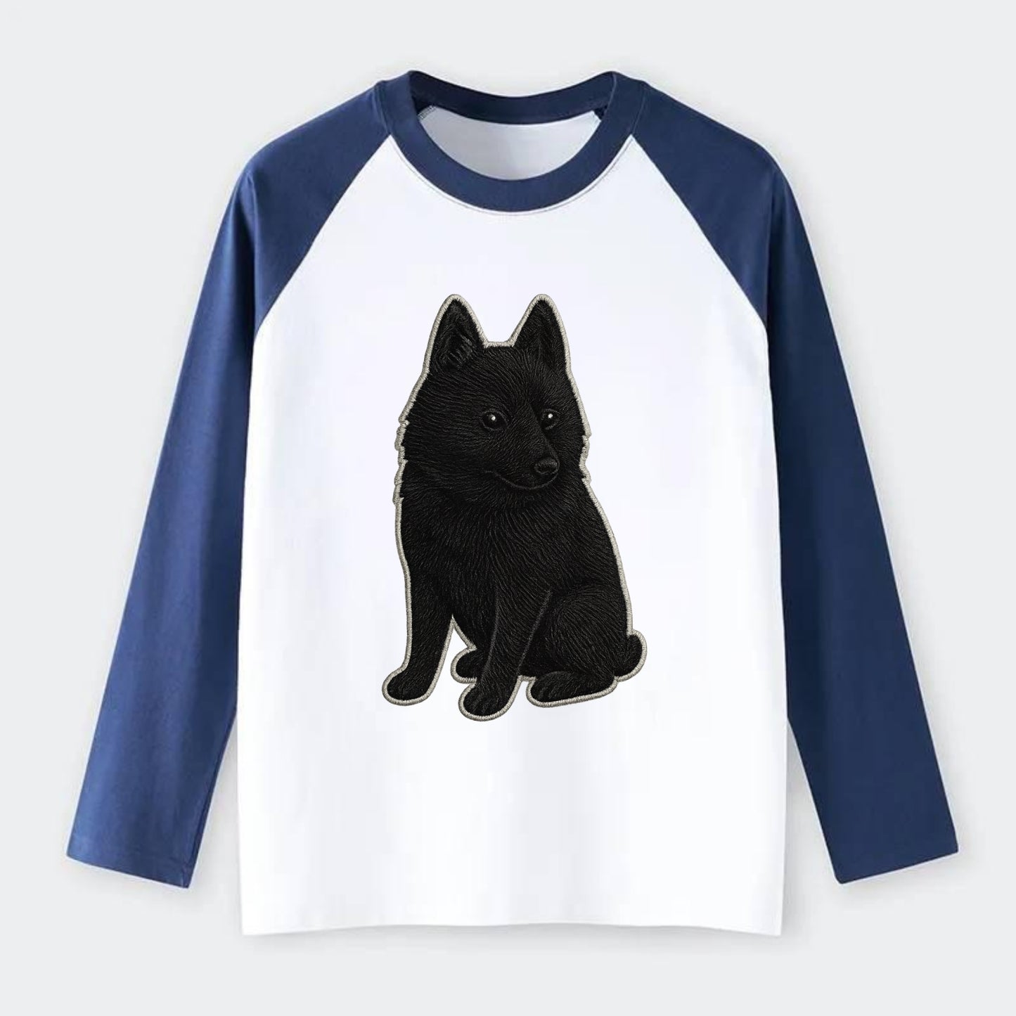 Schipperke - Solid black small embroidered sitting pose - Raglan Long Sleeve T-Shirt - Blue