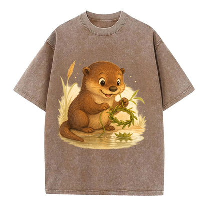 Otter weaving river reeds into a floating crown beside mirror-still water - Vintage T-shirt - Brown