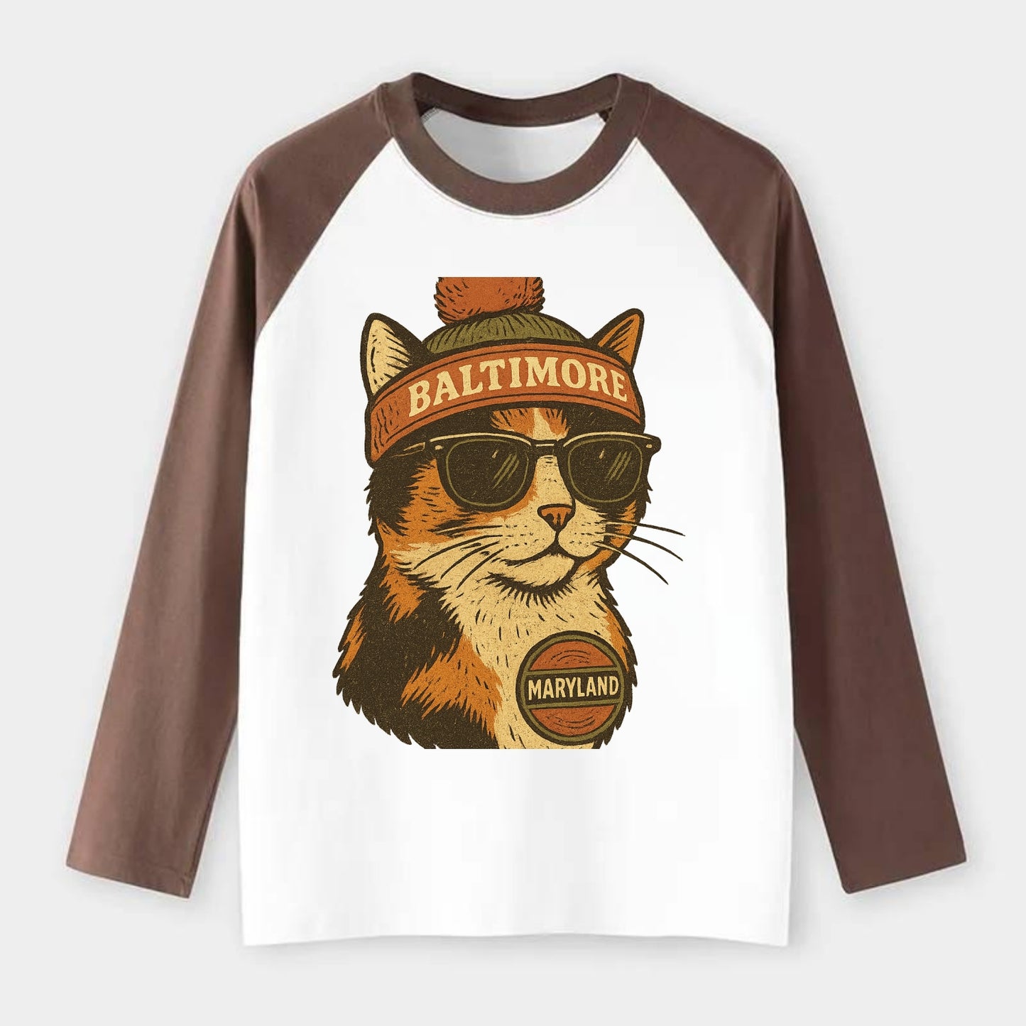 Maryland Calico Cat wearing Baltimore beanie with pom pom and wayfarer - Raglan Long Sleeve T-Shirt - Coffee