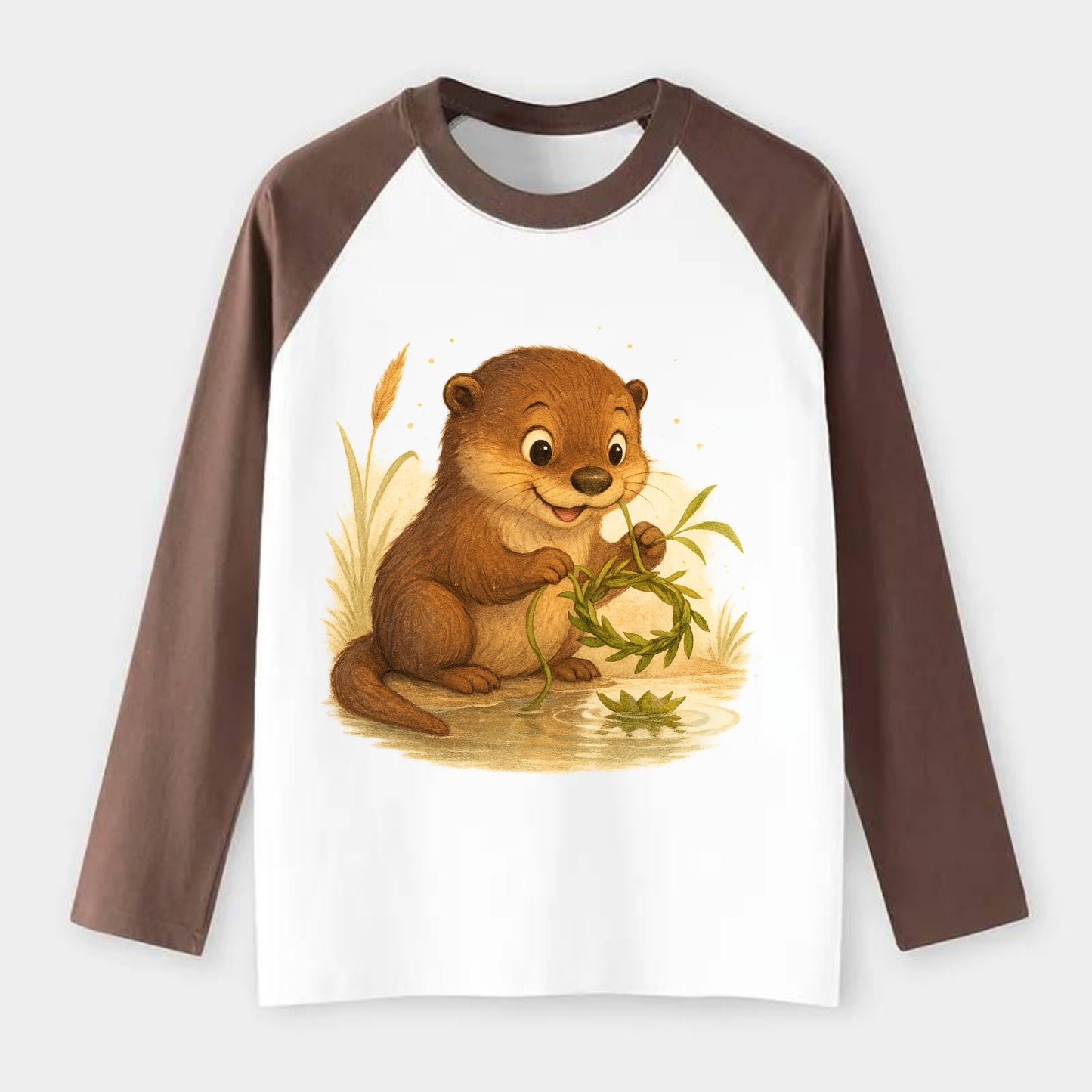 Otter weaving river reeds into a floating crown beside mirror-still - Raglan Long Sleeve T-Shirt - Coffee