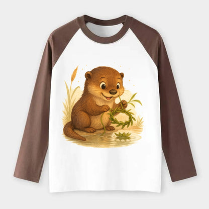Otter weaving river reeds into a floating crown beside mirror-still - Raglan Long Sleeve T-Shirt - Coffee