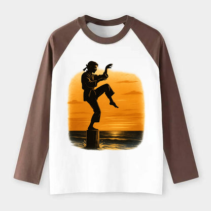 karate crane kick pose on wooden post at beach sunset - Raglan Long Sleeve T-Shirt - Coffee