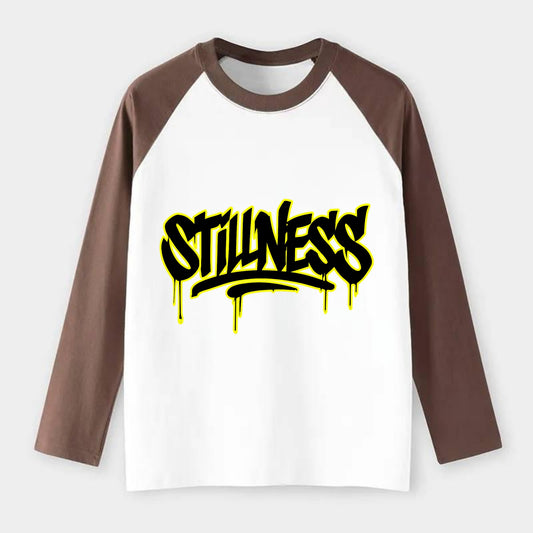 Bold typography design - "STILLNESS" - quiet power, peaceful presence - Raglan Long Sleeve T-Shirt - Coffee