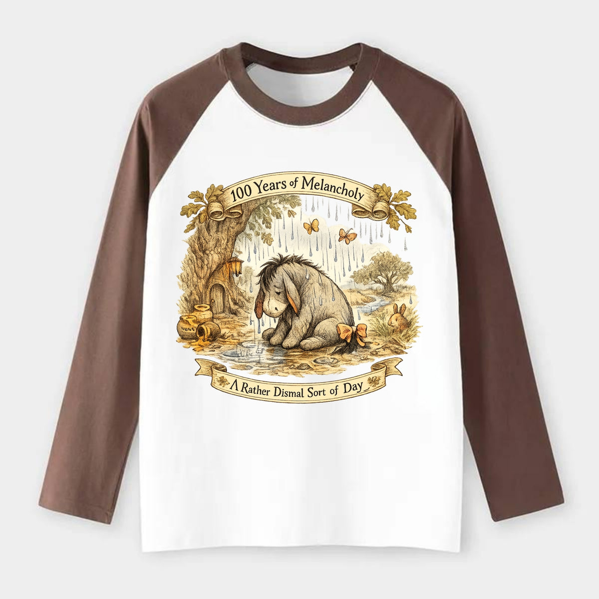 GLOOMY GLEN | Droopy figure in rain | Tattered tail bow | Pessimistic - Raglan Long Sleeve T-Shirt - Coffee