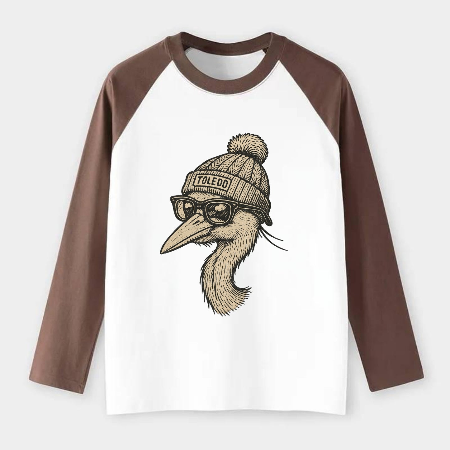 Toledo Great Blue Heron wearing Toledo beanie with pom pom and - Raglan Long Sleeve T-Shirt - Coffee