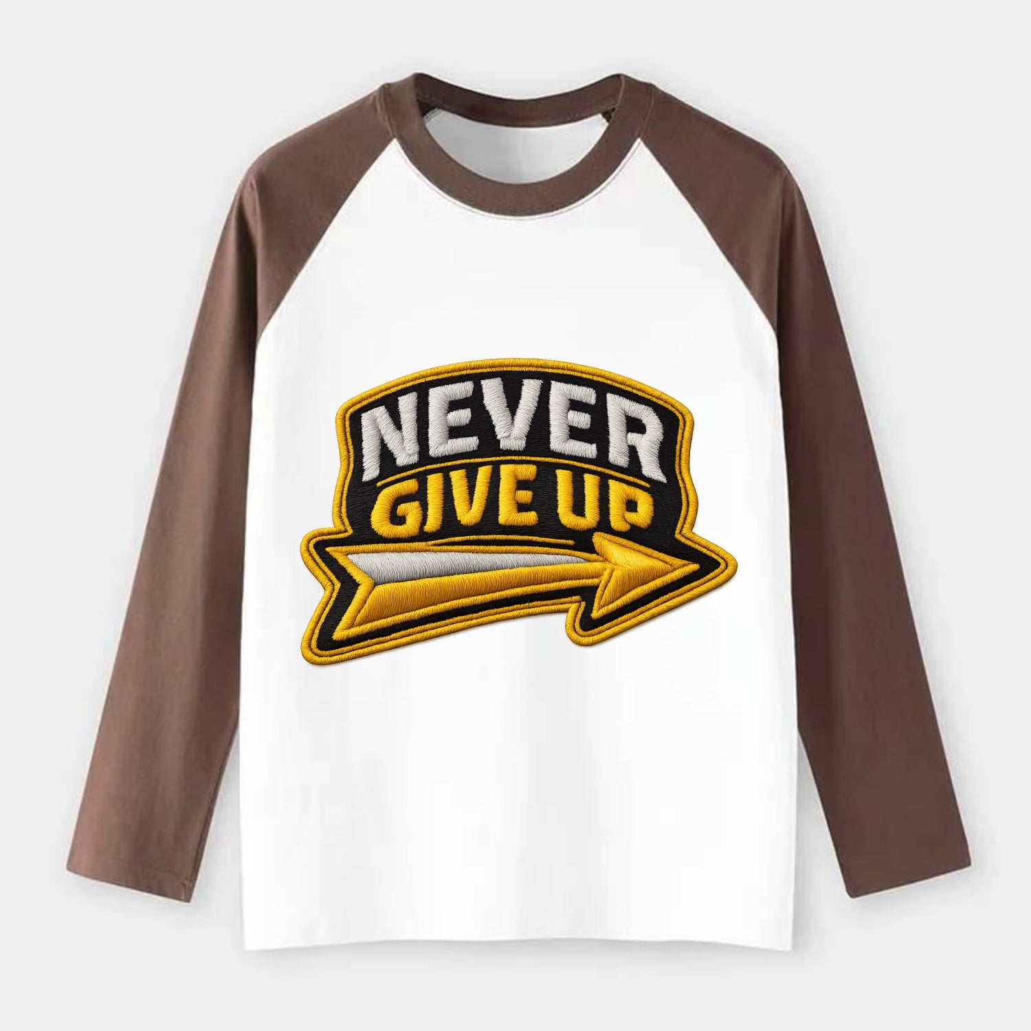 NEVER GIVE UP - bold text with arrow in gold , determination - Raglan Long Sleeve T-Shirt - Coffee