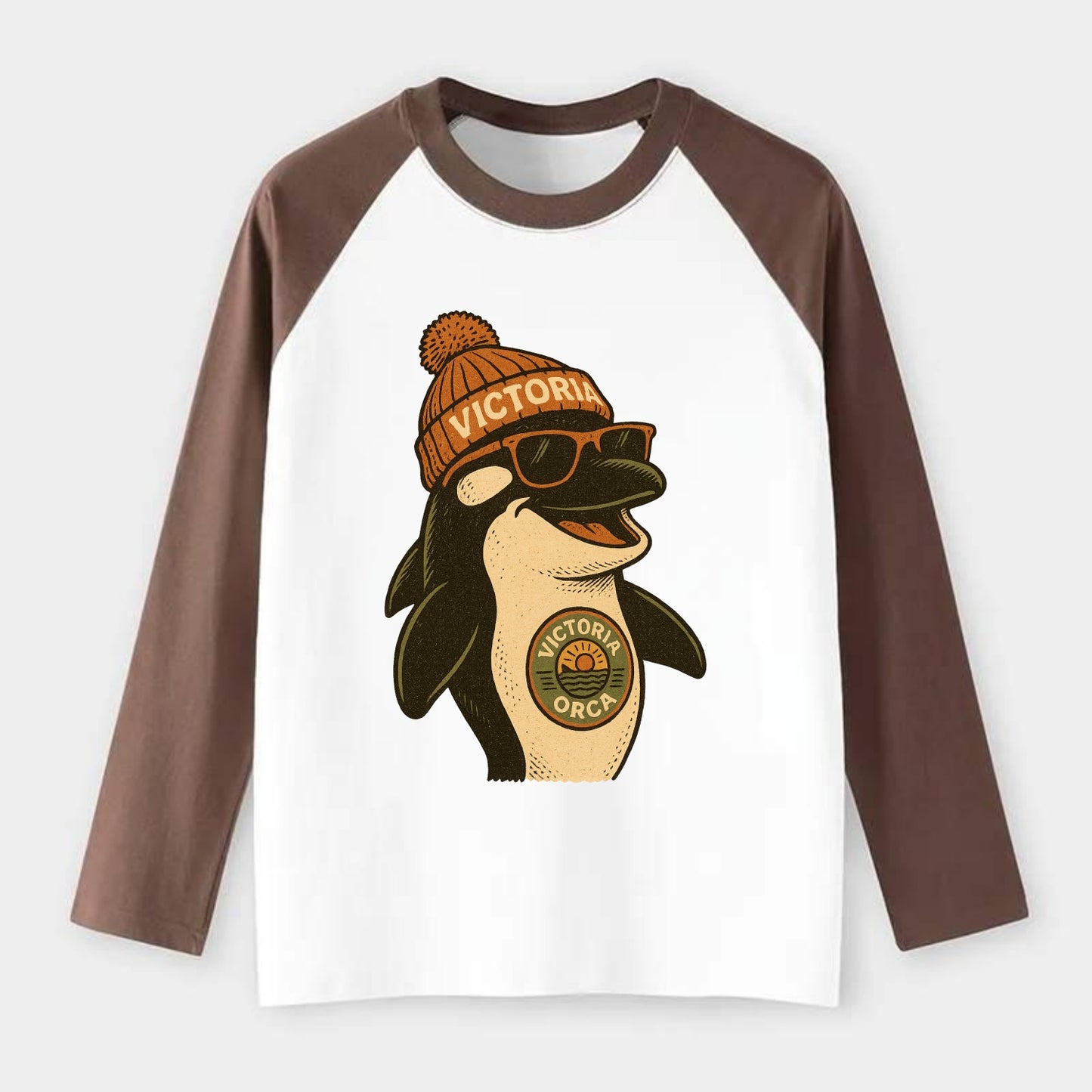 Victoria Orca wearing Victoria beanie wi - Raglan Long Sleeve T-Shirt - Coffee