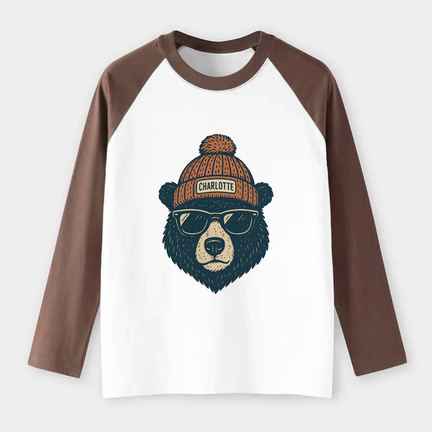North Carolina Black Bear wearing Charlotte beanie with pom pom and - Raglan Long Sleeve T-Shirt - Coffee