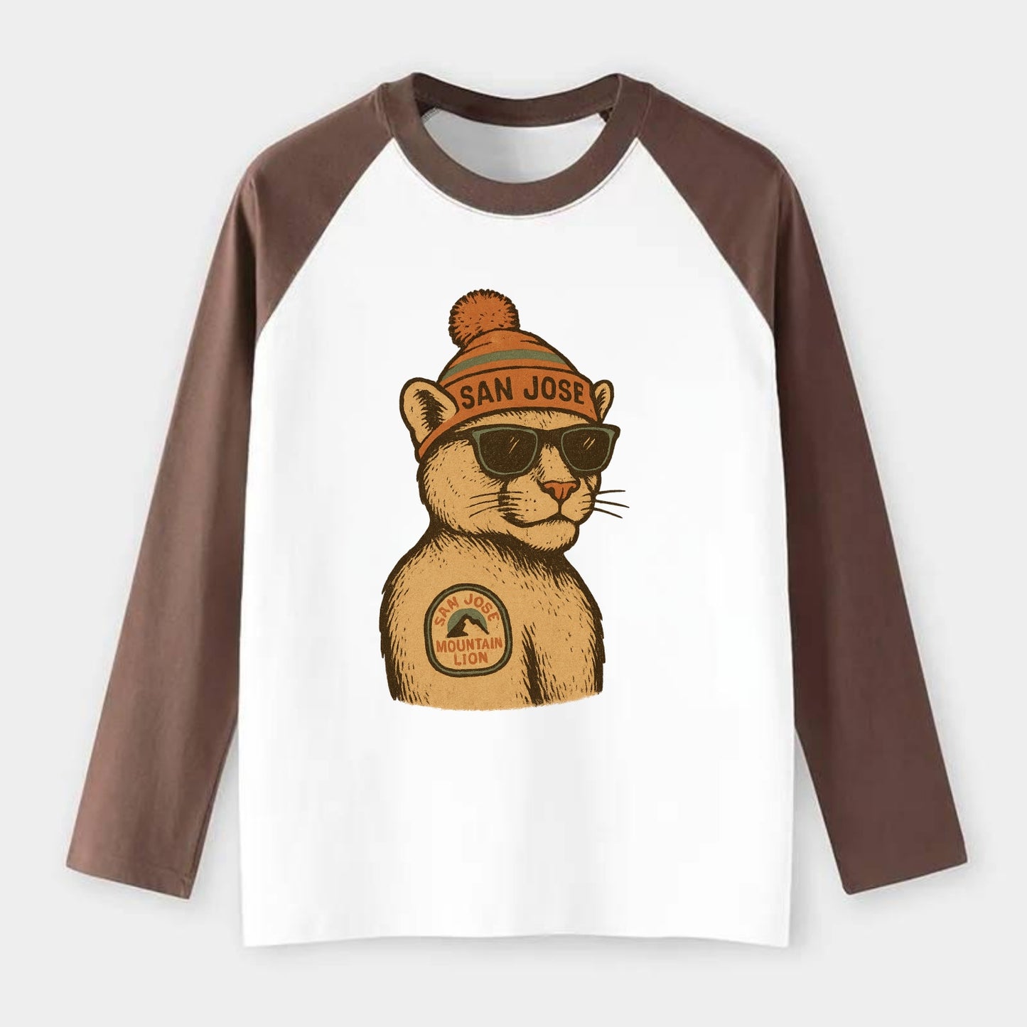 San Jose Mountain Lion wearing San Jose beanie with pom pom and - Raglan Long Sleeve T-Shirt - Coffee