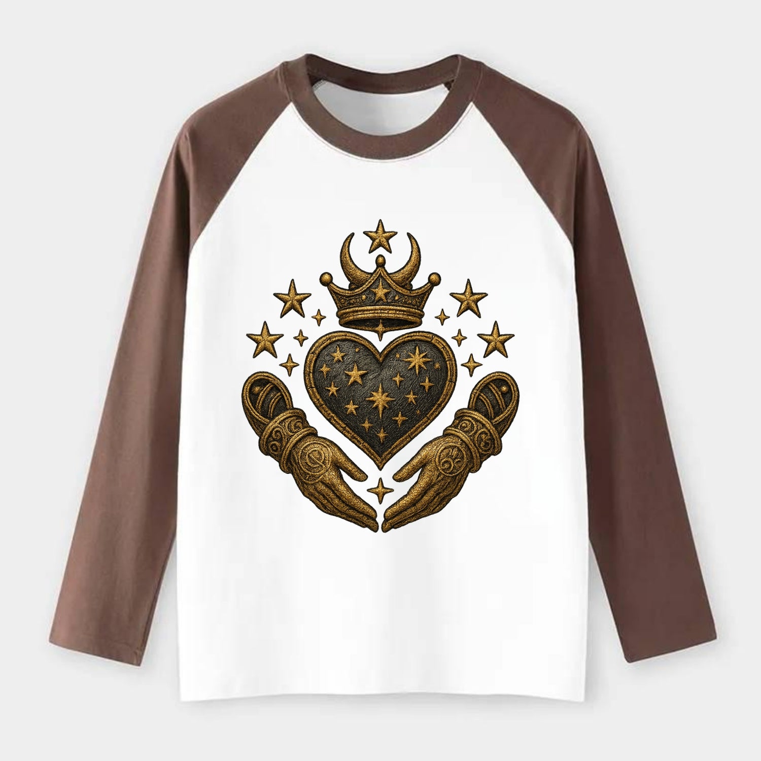 Weathered antique brass crown above a hammered gunmetal heart framed - Raglan Long Sleeve T-Shirt - Coffee