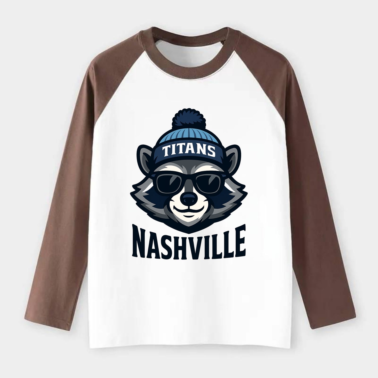 Nashville Raccoon wearing Titans navy and light blue beanie with pom - Raglan Long Sleeve T-Shirt - Coffee