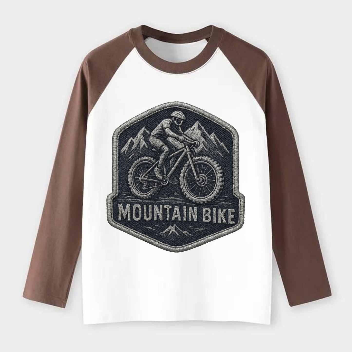 Mountain bike with rugged tires - cyclist badge - Raglan Long Sleeve T-Shirt - Coffee