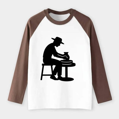 Potter shaping clay on wheel - Raglan Long Sleeve T-Shirt - Coffee