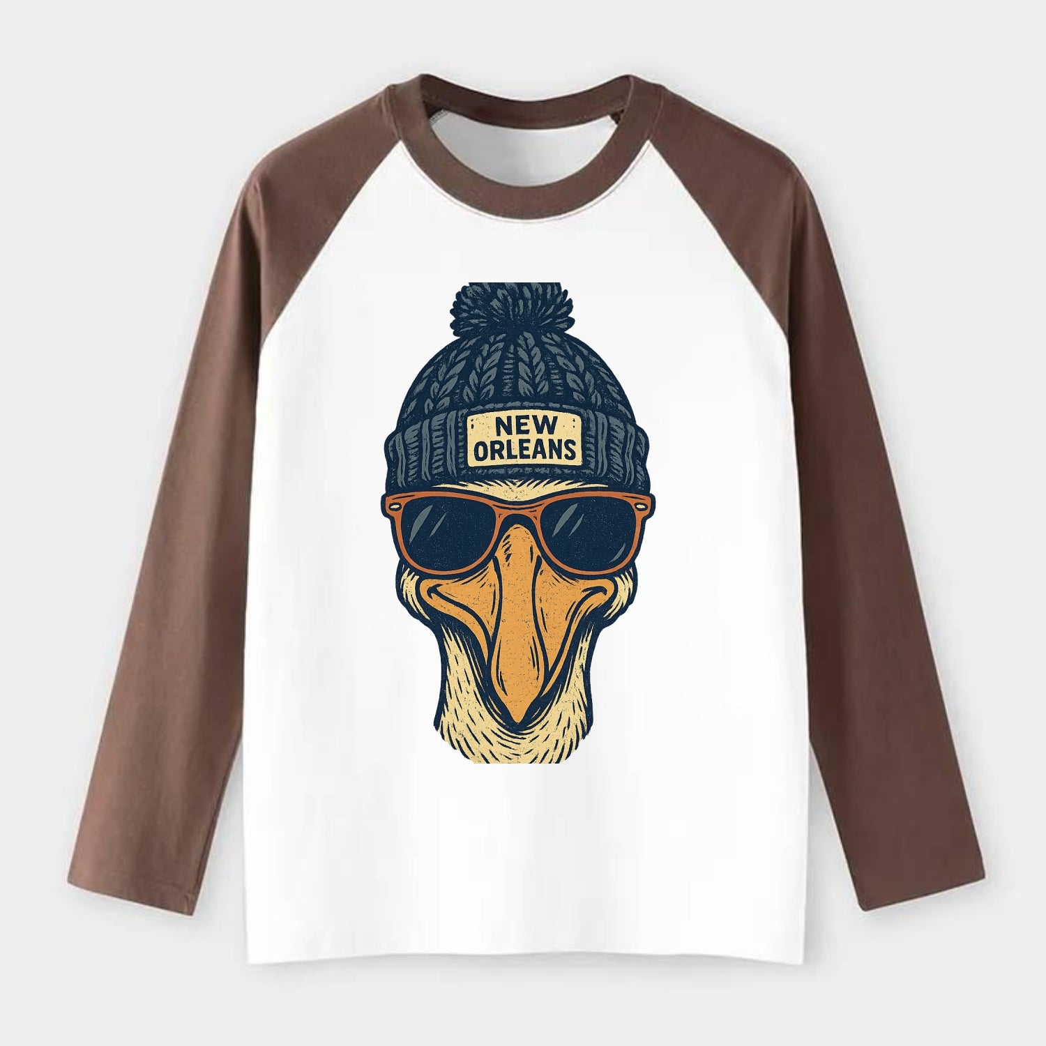 New Orleans Pelican wearing New Orleans beanie with pom pom and - Raglan Long Sleeve T-Shirt - Coffee