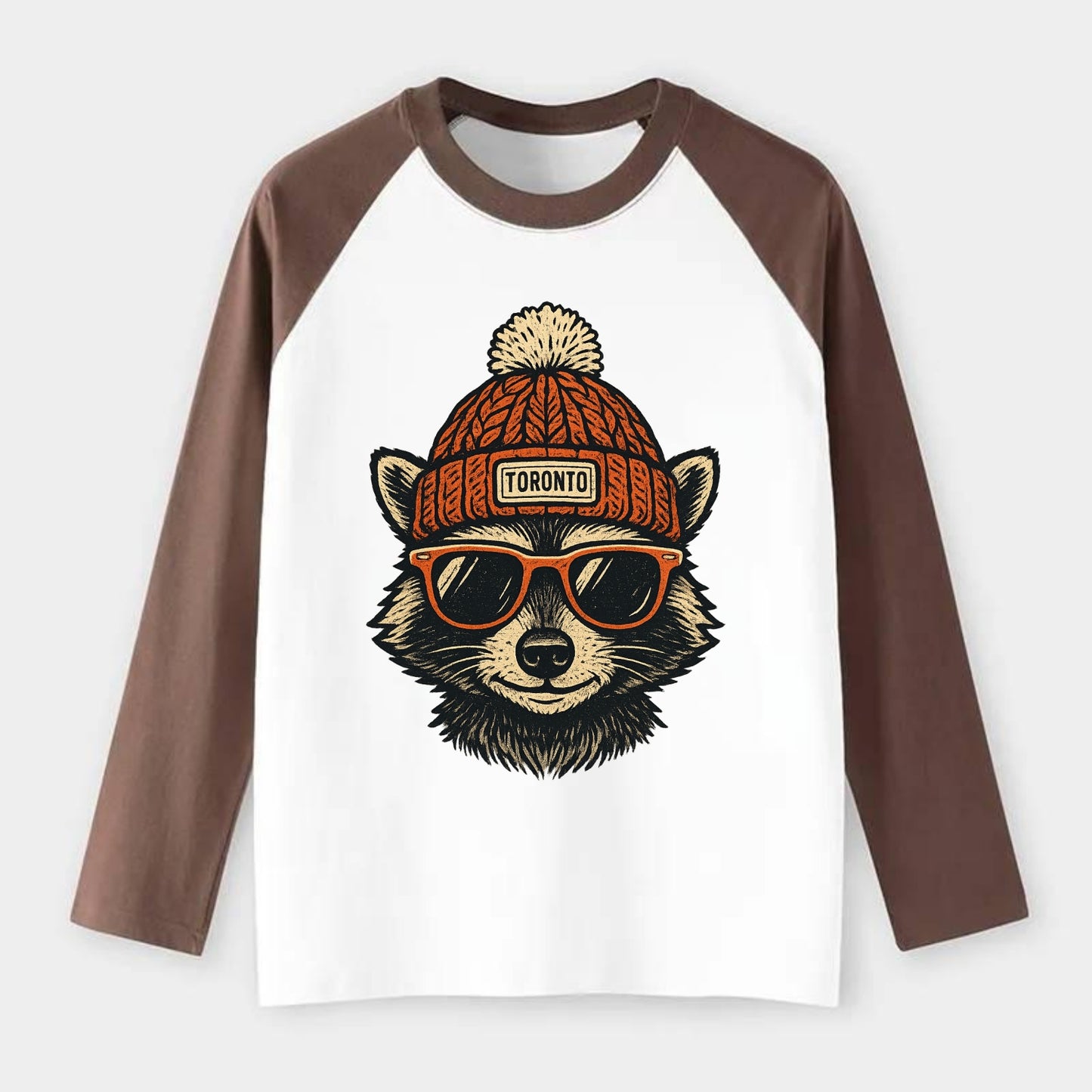 Toronto Raccoon wearing Toronto beanie with pom pom and wayfarer - Raglan Long Sleeve T-Shirt - Coffee