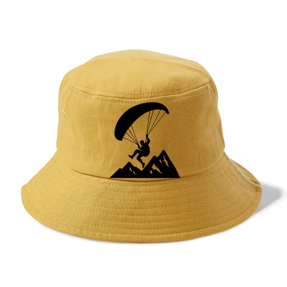 Paraglider soaring over mountain peaks - Bucket Hat - Golden Harvest(Yellow)