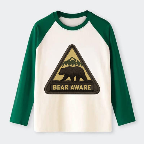 BEAR AWARE - bear silhouette warning in brown and yellow , wilderness - Raglan Long Sleeve T-Shirt