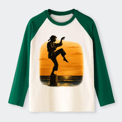 karate crane kick pose on wooden post at beach sunset - Raglan Long Sleeve T-Shirt - Green