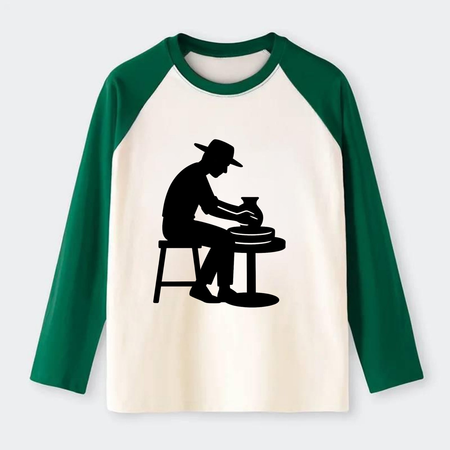 Potter shaping clay on wheel - Raglan Long Sleeve T-Shirt - Green
