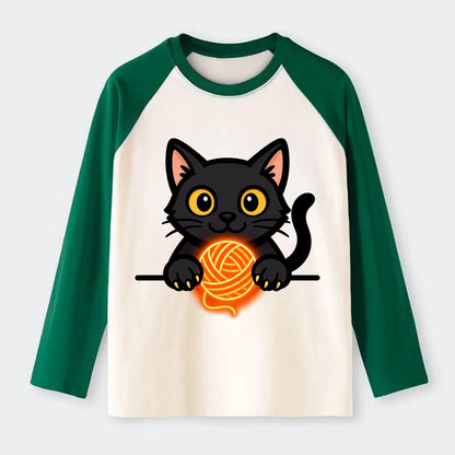 Midnight the black cat popping out of a gift box lid with ribbon - Raglan Long Sleeve T-Shirt - Green