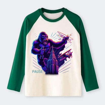 giant gorilla on top of skyscraper holding small figure, swatting - Raglan Long Sleeve T-Shirt - Green