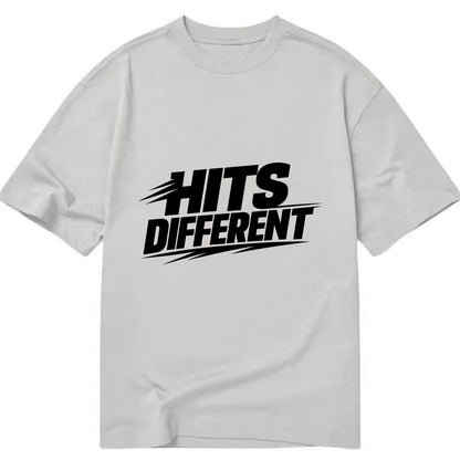 Bold typography design - "HITS DIFFERENT" - uniquely special, stands out - Classic T-shirt - Grey