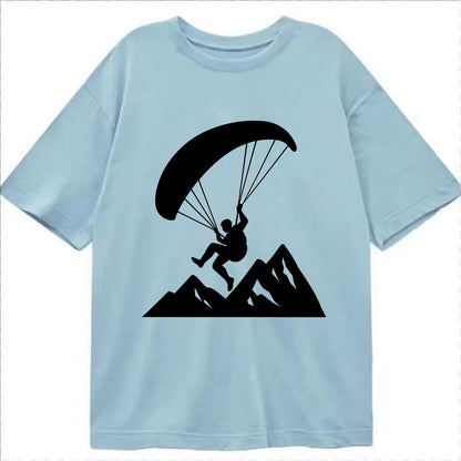 Paraglider soaring over mountain peaks - Classic T-shirt - Light Blue