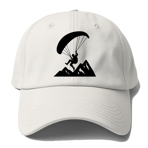 Paraglider soaring over mountain peaks - Baseball Cap