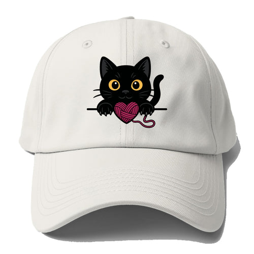 Midnight the black cat stretching tall with claws gently hooked over the edge. - Baseball Cap