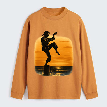 karate crane kick pose on wooden post at beach sunset - Classic Long Sleeve Shirt - Orange