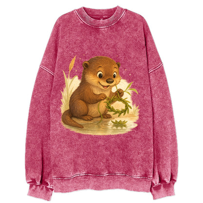 Otter weaving river reeds into a floating crown beside mirror-still water - Vintage Sweatshirt - Pink