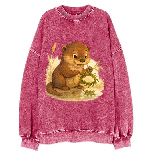 Otter weaving river reeds into a floating crown beside mirror-still water - Vintage Sweatshirt - Pink